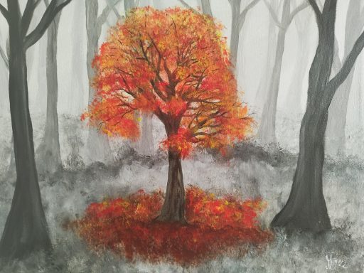 ein bunter Herbstbaum im tristen Herbstgrau